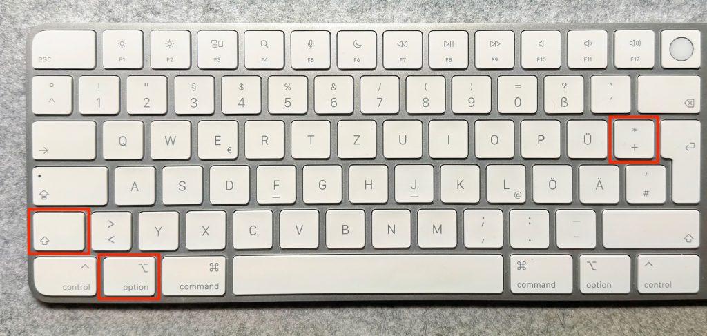 Tastenkombination für Apple-Icon Tastenkombination Option + Shift + Plus auf einer Mac-Tastatur.